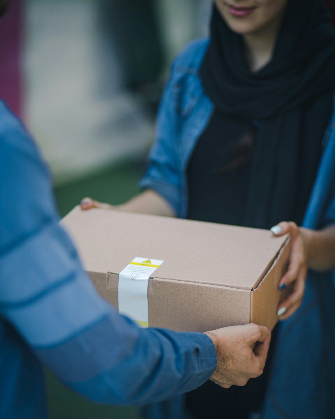 Stedfasts courier handing over a parcel