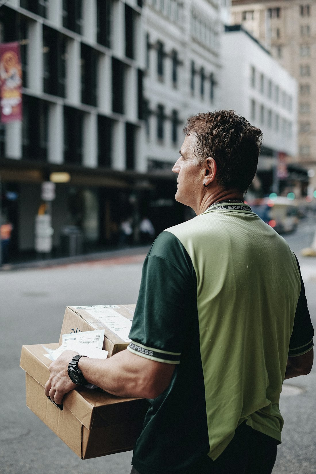 Stedfasts delivery driver holding a parcel, ready for a route