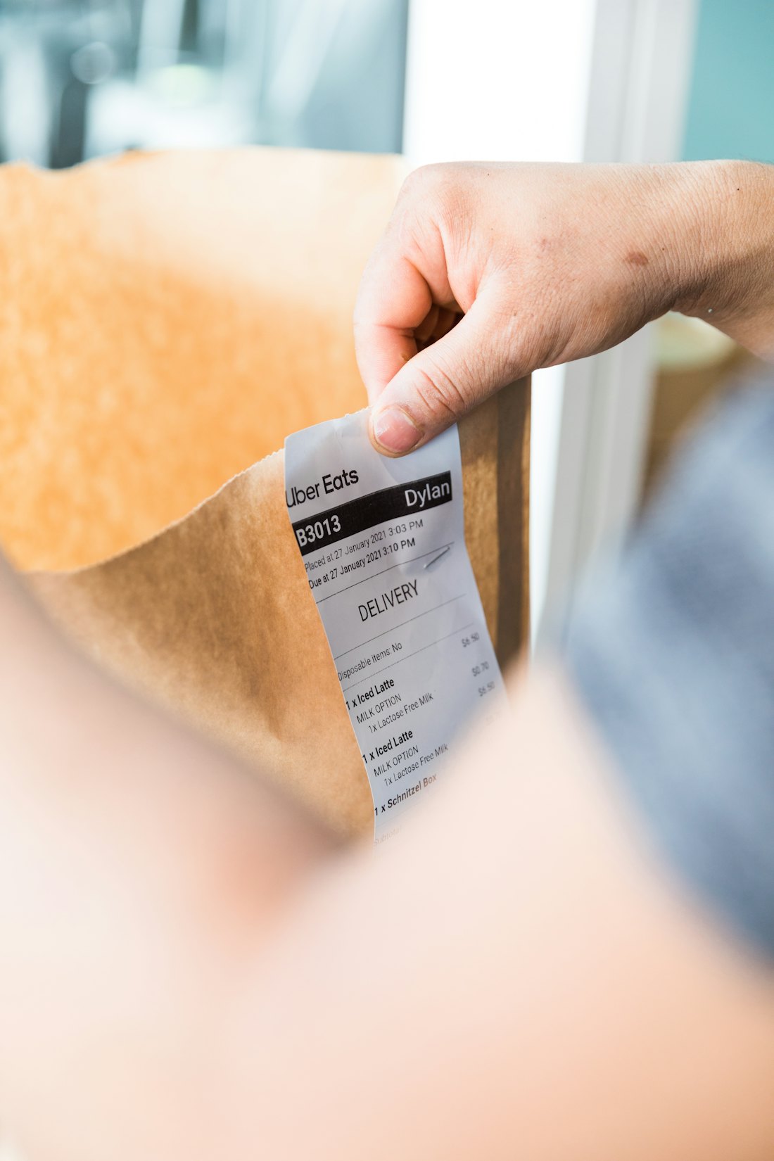 Customer opening a cardboard e-commerce parcel delivered by Stedfasts