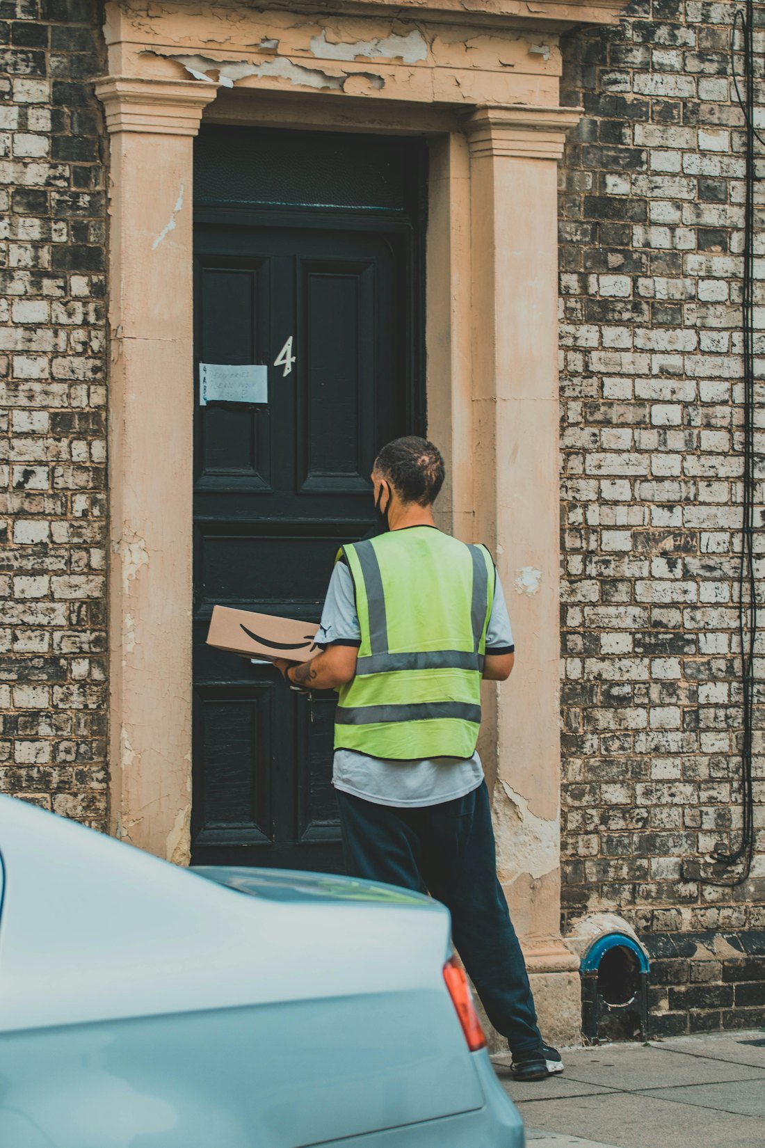 Stedfasts worker in a hi-vis vest sorting parcels at a sortation hub